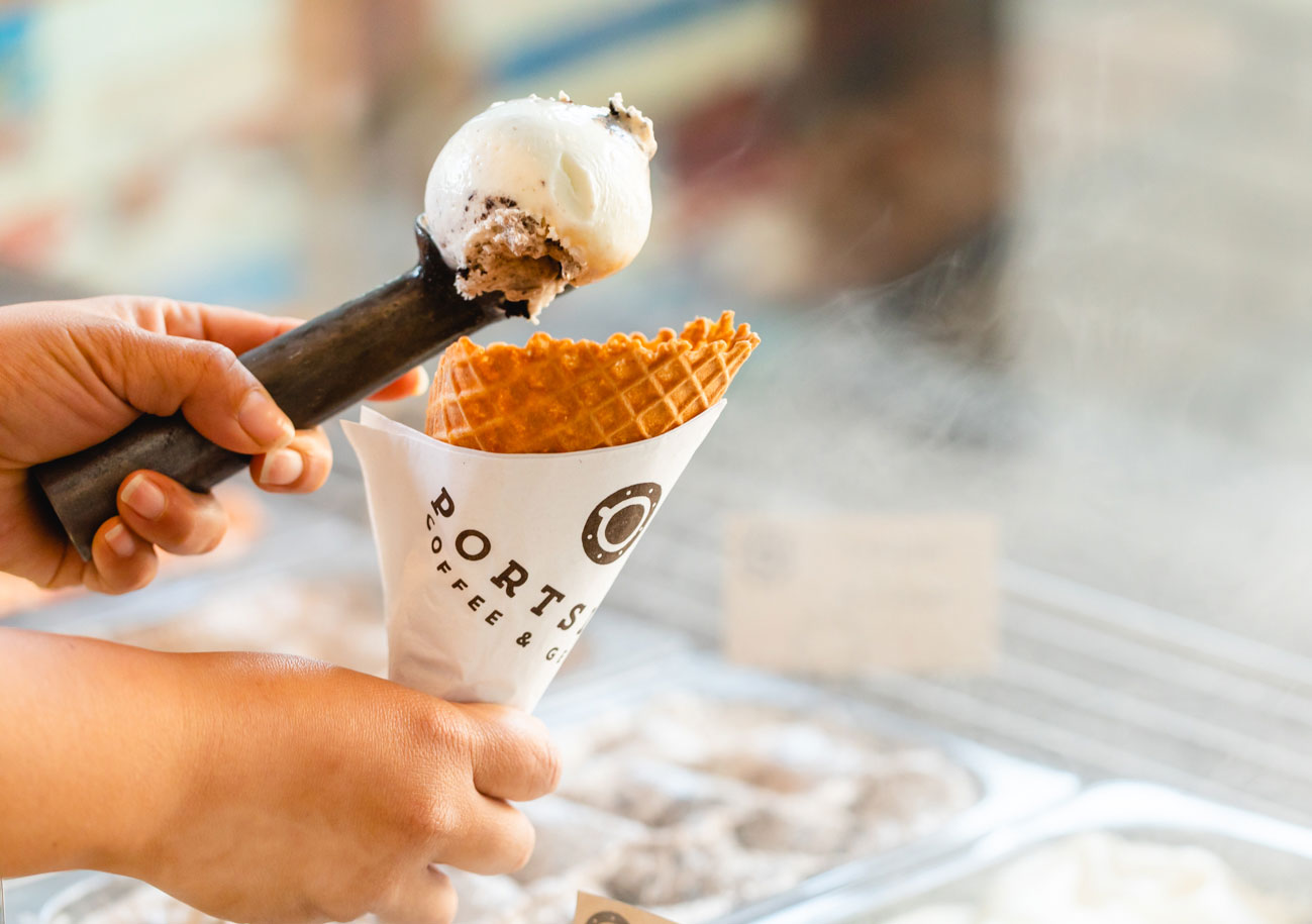 hands scooping gelato into waffle cone at portside coffee and gelato